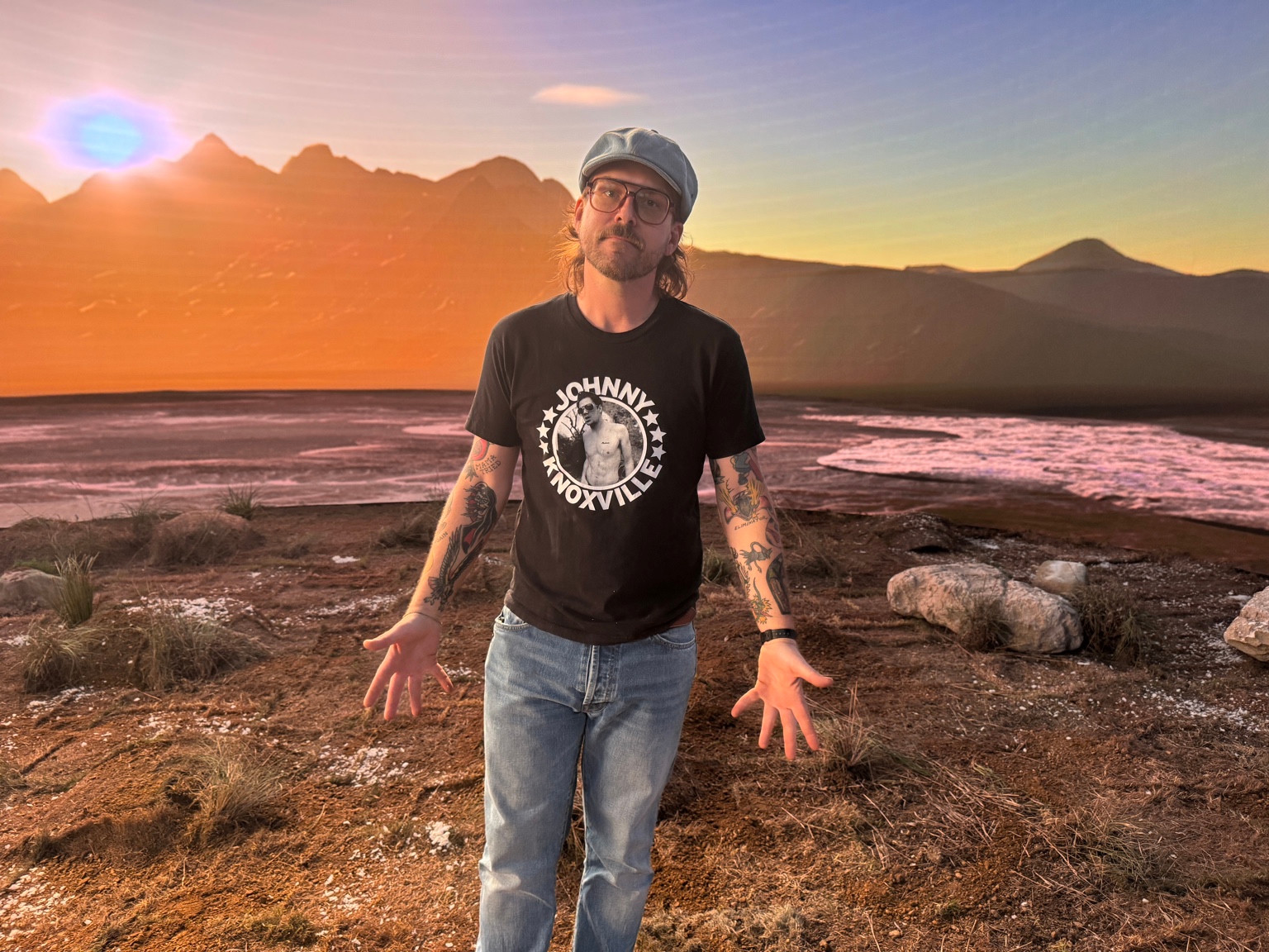 Matt Egan standing in front of a warm sunset landscape backdrop.